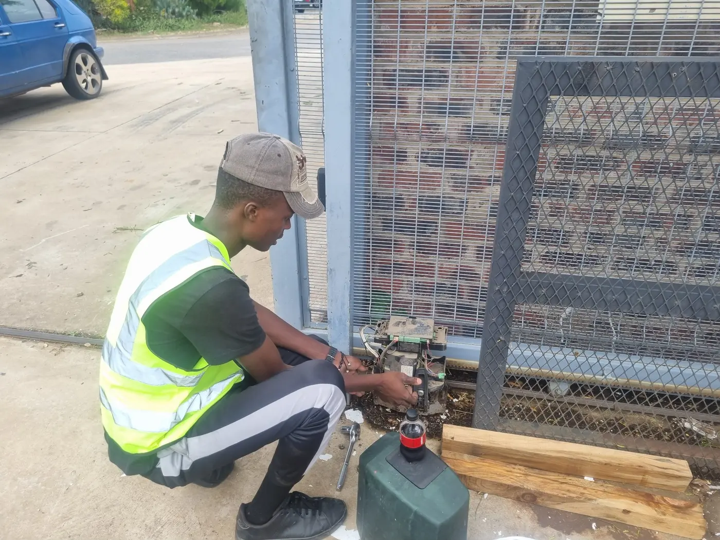 Prime Secure Systems technician repairing a sliding gate motor for Security Systems, Garage Doors & Gate Automation